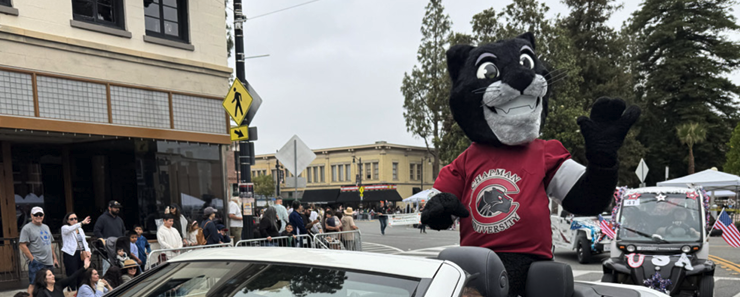 Paws up! Pete the Panther rides through the Orange May Parade, sharing Chapman spirit with the community.